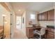 Hallway featuring a built-in desk, neutral walls and carpet, with an adjacent sitting area at 2408 E Fiesta Dr, Casa Grande, AZ 85194