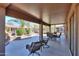 Inviting covered patio with seating and dining areas, plus a landscaped backyard with mature trees at 2408 E Fiesta Dr, Casa Grande, AZ 85194