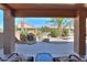 Covered patio with outdoor seating area and view of landscaped backyard with a fountain at 2408 E Fiesta Dr, Casa Grande, AZ 85194
