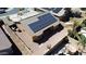 Aerial view of a home with solar panels on the roof, a fenced yard and a small pool at 25564 W Magnolia St, Buckeye, AZ 85326