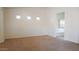 Spacious, neutral-toned bedroom with three small windows, bright natural light, and an attached bathroom at 25564 W Magnolia St, Buckeye, AZ 85326