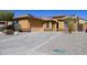 Lovely single-story home with desert landscaping, attached garage, and solar panels on a sunny day at 25564 W Magnolia St, Buckeye, AZ 85326