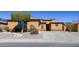 Charming single-story home with desert landscaping and a covered entrance on a sunny day at 25564 W Magnolia St, Buckeye, AZ 85326