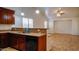 Inviting kitchen with stainless steel sink, a dishwasher, and an open layout towards the adjacent dining area at 25564 W Magnolia St, Buckeye, AZ 85326