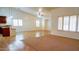 Open living room with tile flooring, ceiling fan, neutral paint, and natural light at 25564 W Magnolia St, Buckeye, AZ 85326