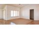 Open living room with tile flooring, neutral paint, and natural light at 25564 W Magnolia St, Buckeye, AZ 85326