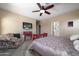 Comfortable bedroom with a ceiling fan, television, and doorway to the bathroom at 2910 W Allens Peak Dr, San Tan Valley, AZ 85144