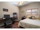 Comfortable bedroom featuring a ceiling fan, desk, and wood floors at 2910 W Allens Peak Dr, San Tan Valley, AZ 85144