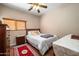 Cozy bedroom with a ceiling fan, wood floor and red decorative rug at 2910 W Allens Peak Dr, San Tan Valley, AZ 85144