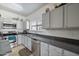 Spacious kitchen featuring stainless steel appliances, gray cabinets, modern countertops and a mosaic tile backsplash at 2910 W Allens Peak Dr, San Tan Valley, AZ 85144