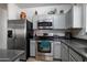 Well-equipped kitchen featuring stainless steel appliances, gray cabinets, and stylish backsplash at 2910 W Allens Peak Dr, San Tan Valley, AZ 85144