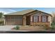 Charming single-story home featuring a stone facade, a two-car garage, and a well-manicured front yard at 2966 E Bellerive Dr, Gilbert, AZ 85298