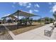 Community playground with shaded play structures, picnic area, and walking paths under a sunny sky at 2966 E Bellerive Dr, Gilbert, AZ 85298