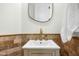Powder room featuring a modern sink, vanity, and a decorative mirror at 3226 E Sells Dr, Phoenix, AZ 85018