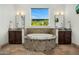 Stunning bathroom showcasing a tiled tub with granite trim, and sinks, and a picturesque window view at 3226 E Sells Dr, Phoenix, AZ 85018
