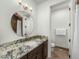 Bathroom boasting a granite countertop, round mirror, and modern fixtures at 3226 E Sells Dr, Phoenix, AZ 85018