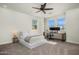 Bedroom with a comfortable bed, a ceiling fan, and a work area by the windows at 3226 E Sells Dr, Phoenix, AZ 85018