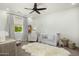 Bright Bedroom with modern ceiling fan, day bed, white crib, rocking chair, and cozy rug at 3226 E Sells Dr, Phoenix, AZ 85018