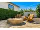 Relaxing fire pit area with stone surround and comfortable wooden Adirondack seating at 3226 E Sells Dr, Phoenix, AZ 85018