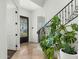 Inviting foyer with stone floors, an elegant staircase, and a decorative front door at 3226 E Sells Dr, Phoenix, AZ 85018