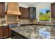 Gourmet kitchen featuring granite countertops, stainless steel appliances, and custom cabinetry at 3226 E Sells Dr, Phoenix, AZ 85018