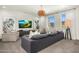 Living room featuring a comfortable gray sofa, modern decor, and bright natural light at 3226 E Sells Dr, Phoenix, AZ 85018