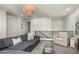 Living room with comfortable seating, modern chandelier, and sleek glass coffee table at 3226 E Sells Dr, Phoenix, AZ 85018