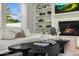 Cozy living room with a fireplace, built-in shelving, and comfortable white sofas at 3226 E Sells Dr, Phoenix, AZ 85018