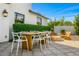 Outdoor dining area with table, chairs, and outdoor lighting, plus a firepit in the background at 3226 E Sells Dr, Phoenix, AZ 85018