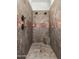 Walk-in shower tiled in earth tones with dual shower heads and a built-in bench at 3226 E Sells Dr, Phoenix, AZ 85018