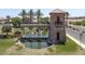 Elegant community entrance with a water feature, stone tower, and lush landscaping at 36503 W San Ildefanso Ave, Maricopa, AZ 85138