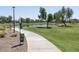 Scenic community park with a lake, walking paths, and grassy areas for recreation at 36503 W San Ildefanso Ave, Maricopa, AZ 85138