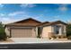 Charming single-story home with a two-car garage, desert landscaping, and stone accents at 36503 W San Ildefanso Ave, Maricopa, AZ 85138