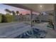Covered patio boasts a spacious backyard view of a pool with mature landscaping and a setting sun at 3702 W Megan St, Chandler, AZ 85226