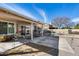 A covered patio with potted plants overlooks a backyard with a pool, offering a relaxing outdoor living space at 3702 W Megan St, Chandler, AZ 85226