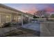 A covered patio with potted plants overlooks a backyard with a pool, offering a relaxing outdoor living space at 3702 W Megan St, Chandler, AZ 85226