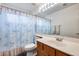 Bright bathroom featuring a single sink vanity, a toilet, and a shower with a fun beach themed curtain at 3702 W Megan St, Chandler, AZ 85226