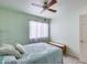 Bright bedroom features a ceiling fan, bedside table and decor, closet and natural lighting at 3702 W Megan St, Chandler, AZ 85226