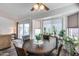 Dining area with round table, seating, sliding door access to the backyard patio and adjacent living room at 3702 W Megan St, Chandler, AZ 85226