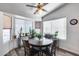 Cozy dining area features a round wood table with seating for four and large windows bringing in natural light at 3702 W Megan St, Chandler, AZ 85226