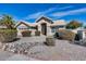 Attractive single-level home featuring a two-car garage and charming desert landscaping in the front yard at 3702 W Megan St, Chandler, AZ 85226