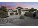 Attractive home exterior with desert landscaping, a covered entryway, and an arched architectural detail at 3702 W Megan St, Chandler, AZ 85226