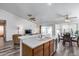 View of the kitchen and dining area with wood cabinets, light countertops, ceiling fans, and sliding door to the patio at 3702 W Megan St, Chandler, AZ 85226