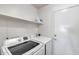 Laundry room features white washer and dryer, overhead shelf and door to the exterior at 3702 W Megan St, Chandler, AZ 85226