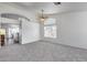Bright living room with high ceilings, large windows, and neutral carpet at 3702 W Megan St, Chandler, AZ 85226