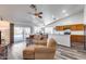 Inviting living room featuring a large window, vaulted ceiling, and seamless flow into the kitchen at 3702 W Megan St, Chandler, AZ 85226