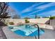 The backyard features a pool with rock features, surrounded by a block wall with a metal pool safety fence at 3702 W Megan St, Chandler, AZ 85226