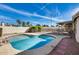 Inviting backyard pool area with a pebble tec pool finish, mature landscaping and brick pavers surrounding it at 3702 W Megan St, Chandler, AZ 85226