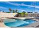 A fenced backyard features a sparkling pool, lush greenery, and clear blue skies, creating a serene retreat at 3702 W Megan St, Chandler, AZ 85226