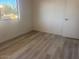 Bedroom featuring wood-look floors and plenty of natural light from a window at 5518 E Lindstrom Ln # B3, Mesa, AZ 85215